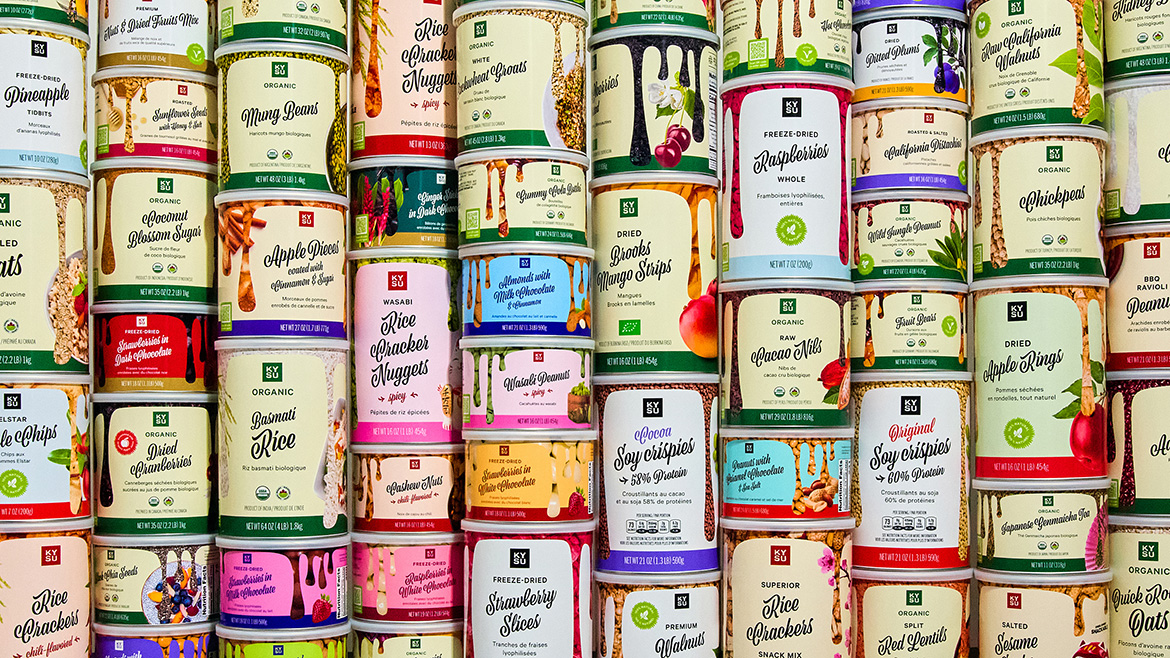 A vibrant display of KYSU’s range of products, all packaged in airtight, recyclable, and reusable paper cans made from 100% recycled materials.