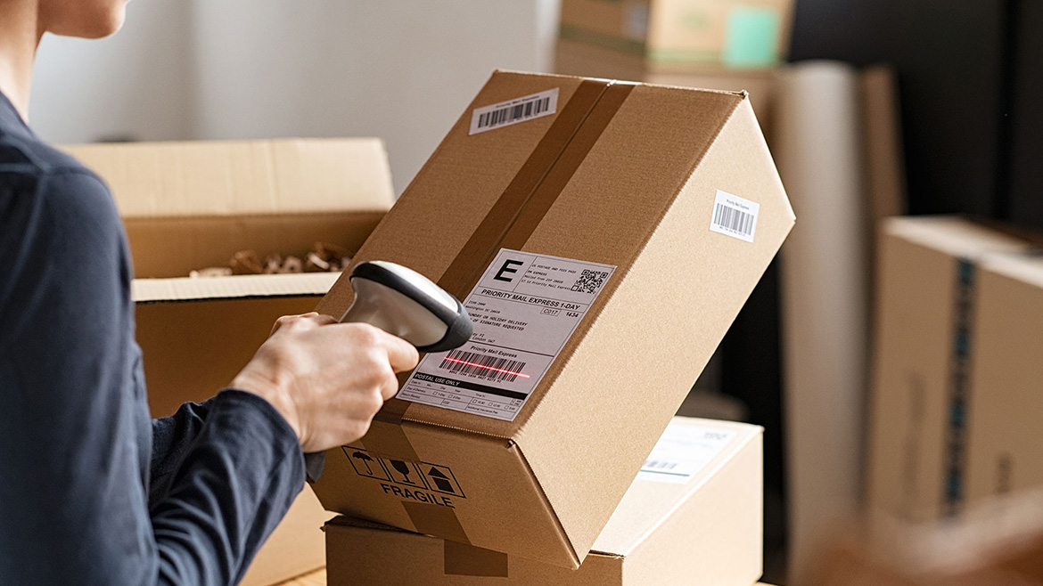 Person scanning a label on a package.